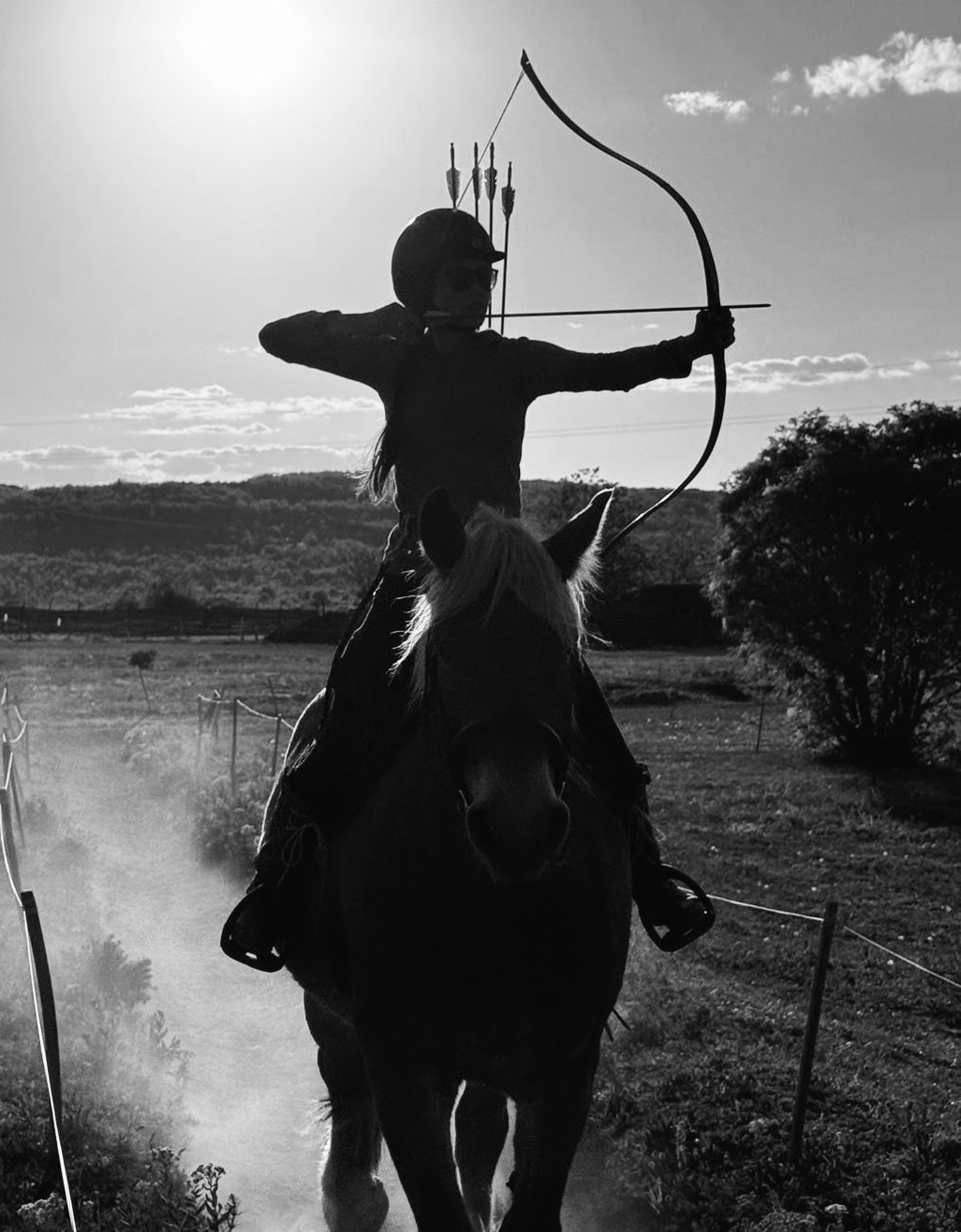 Ramsey shooting a bow on horseback